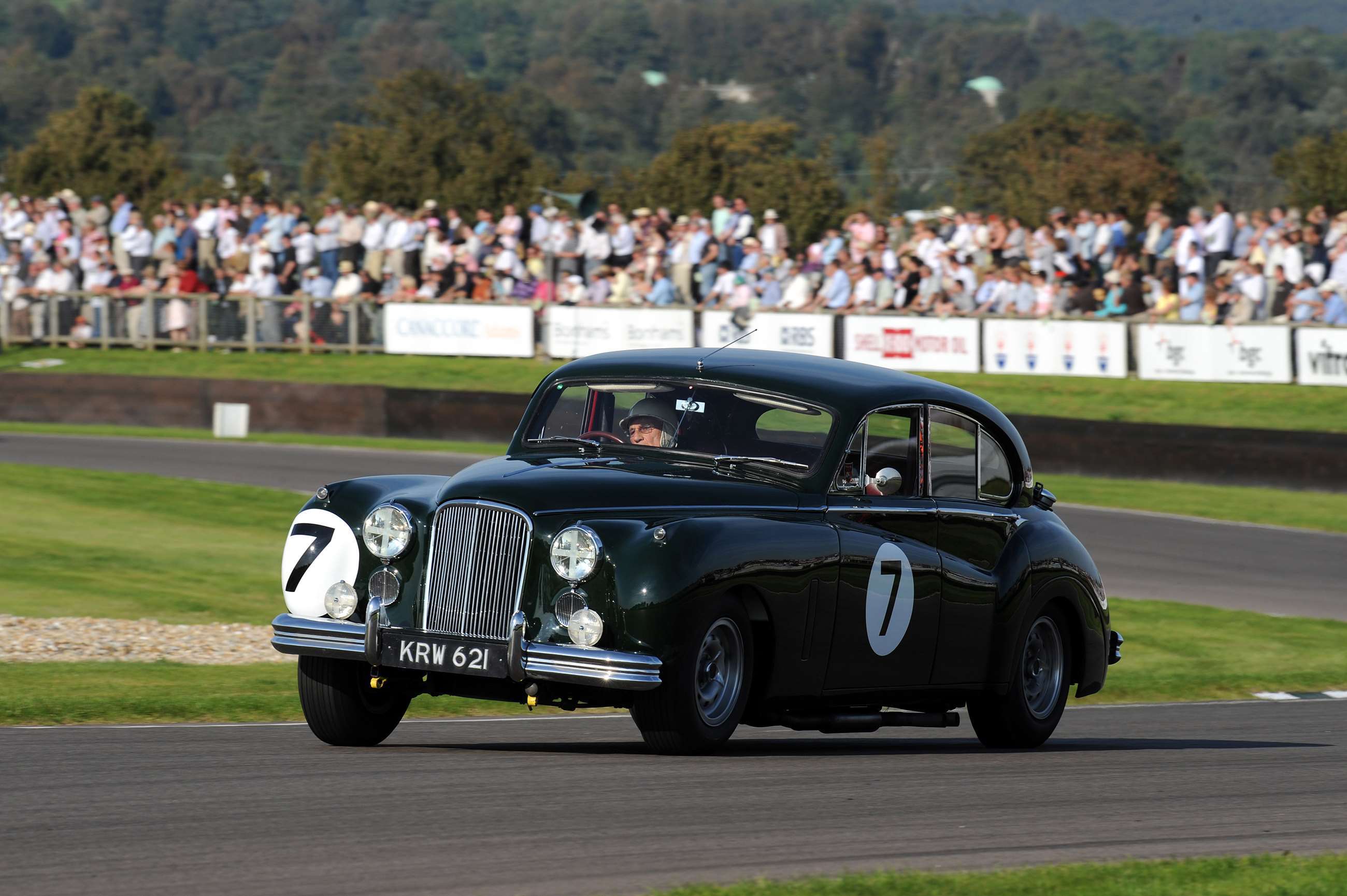 Top, Moss and his wife Susie at the 2012 Revival. Above, Moss racing in the Revival's St Mary's Trophy in 2008.