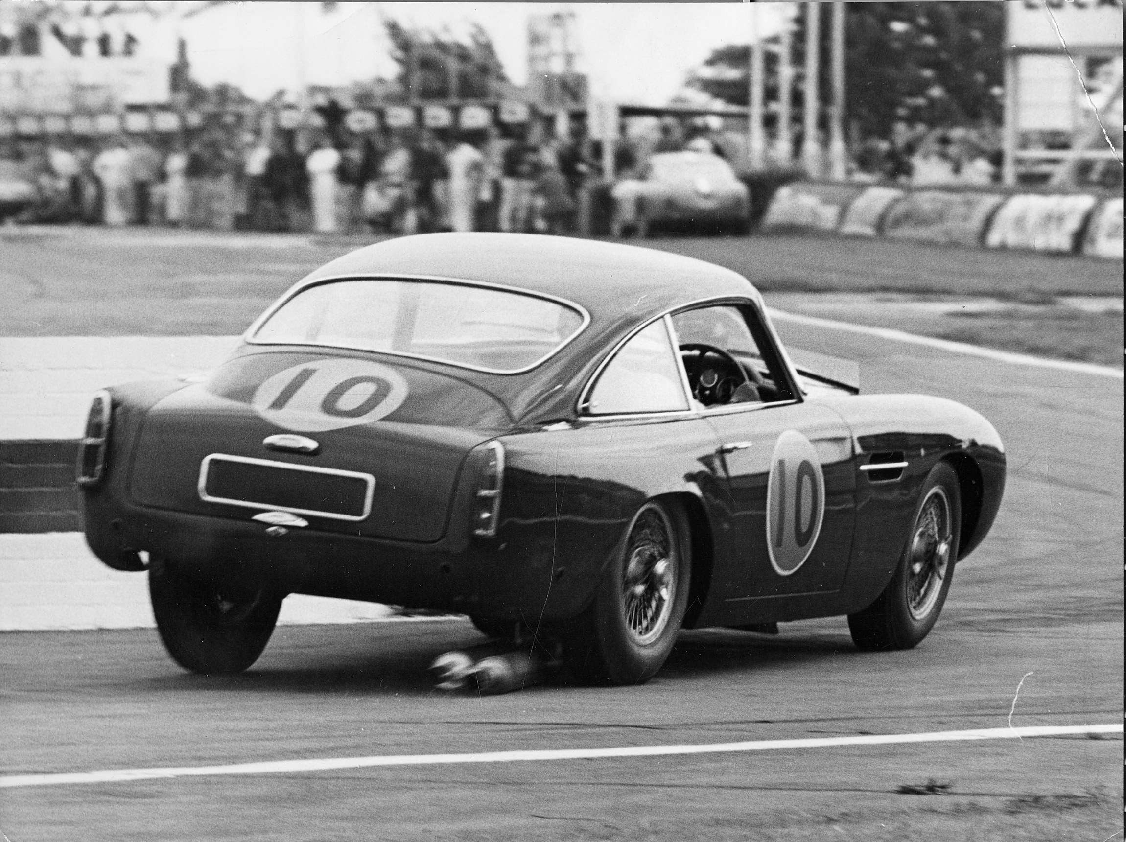 Innes Ireland in John Ogier’s Aston Martin DB4GT - dragging its exhaust through the chicane - 1960 Goodwood Tourist Trophy