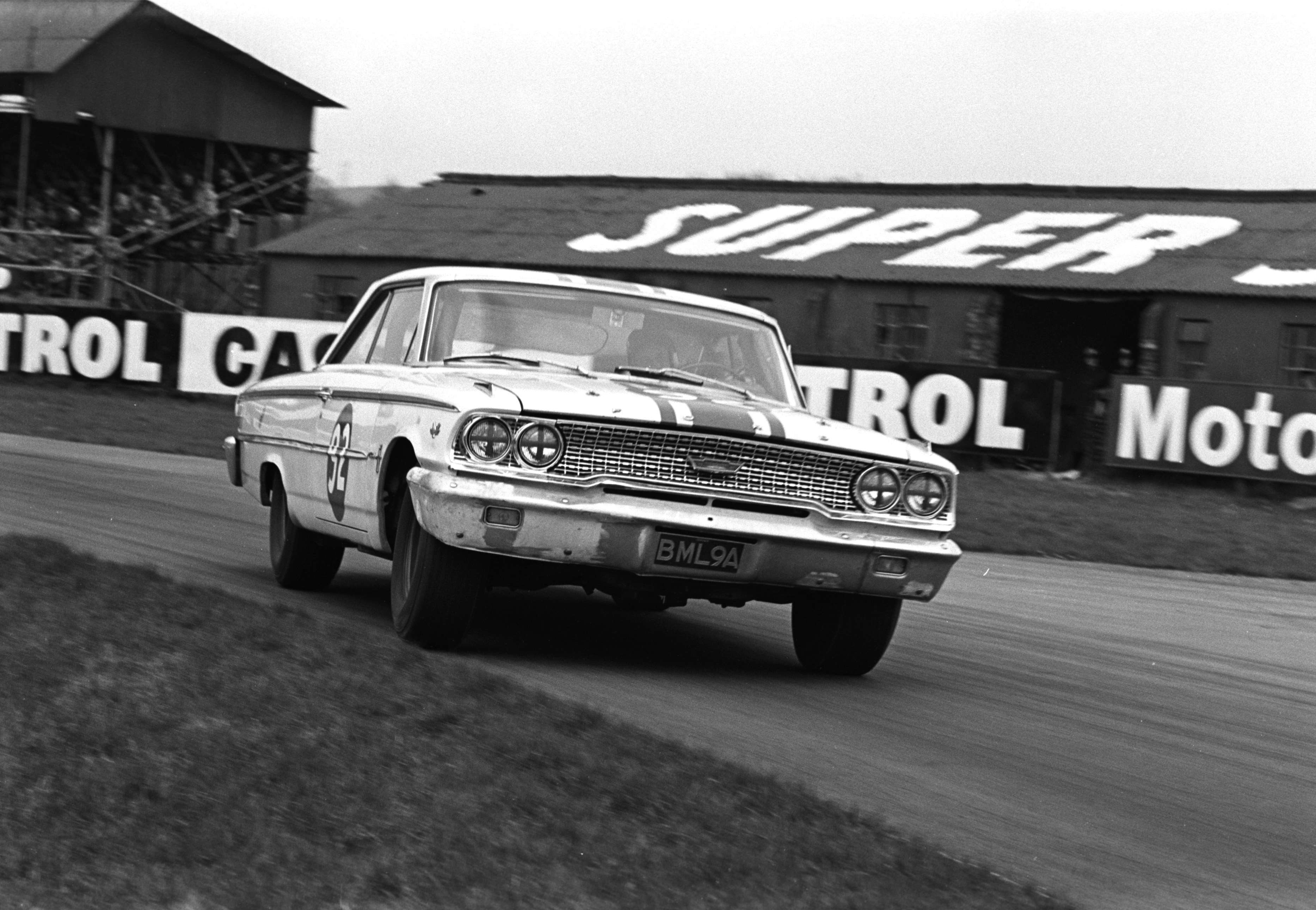 Race winner - Easter Monday Goodwood 1964 - ‘Gentleman Jack’ Sears in the immense Willment Ford Galaxie - storming through Woodcote Corner
