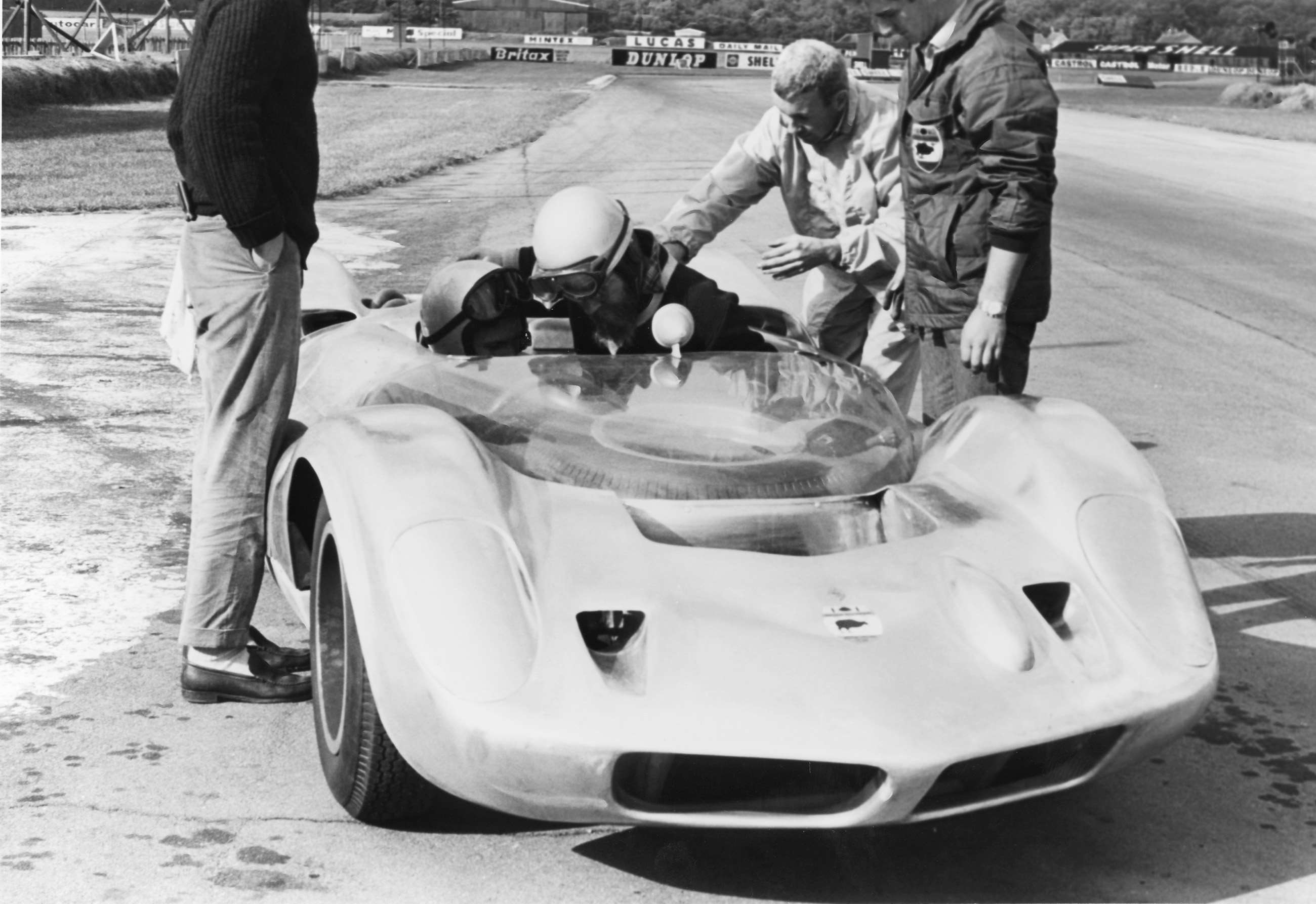 Bruce in the car being joined by Denis Jenkinson - ‘Jenks’ of ‘Motor Sport’ magazine - Bruce’s business partner Teddy Mayer, grey-haired, right.