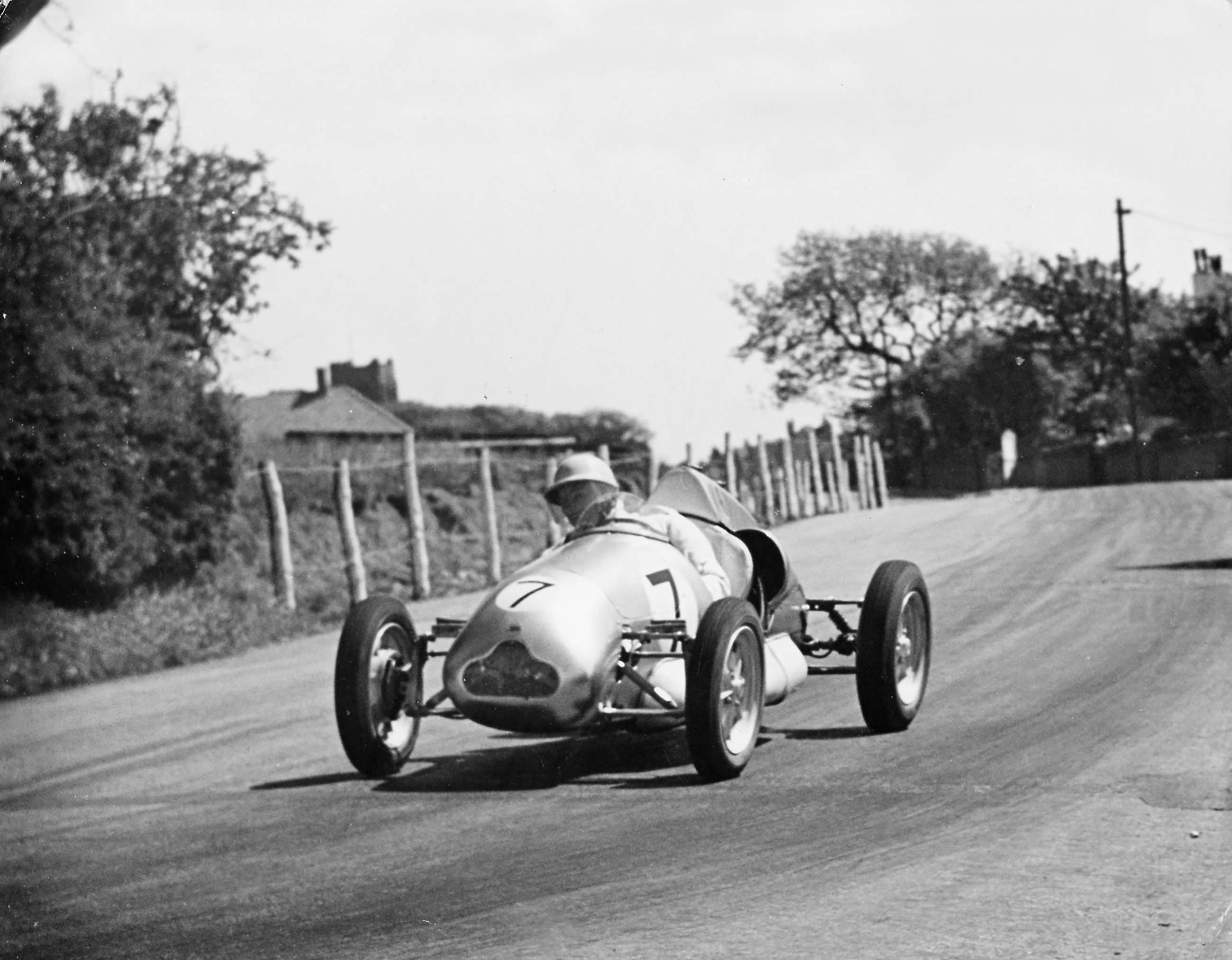 Stirling Moss in his 1,000cc twin-cylinder Cooper-JAP on the Isle of Man, 1949. Top image, Charles Cooper (left) with son John and one of their earliest Cooper-JAP 500cc single-seater racing cars, in Hollyfield Road, Surbiton.