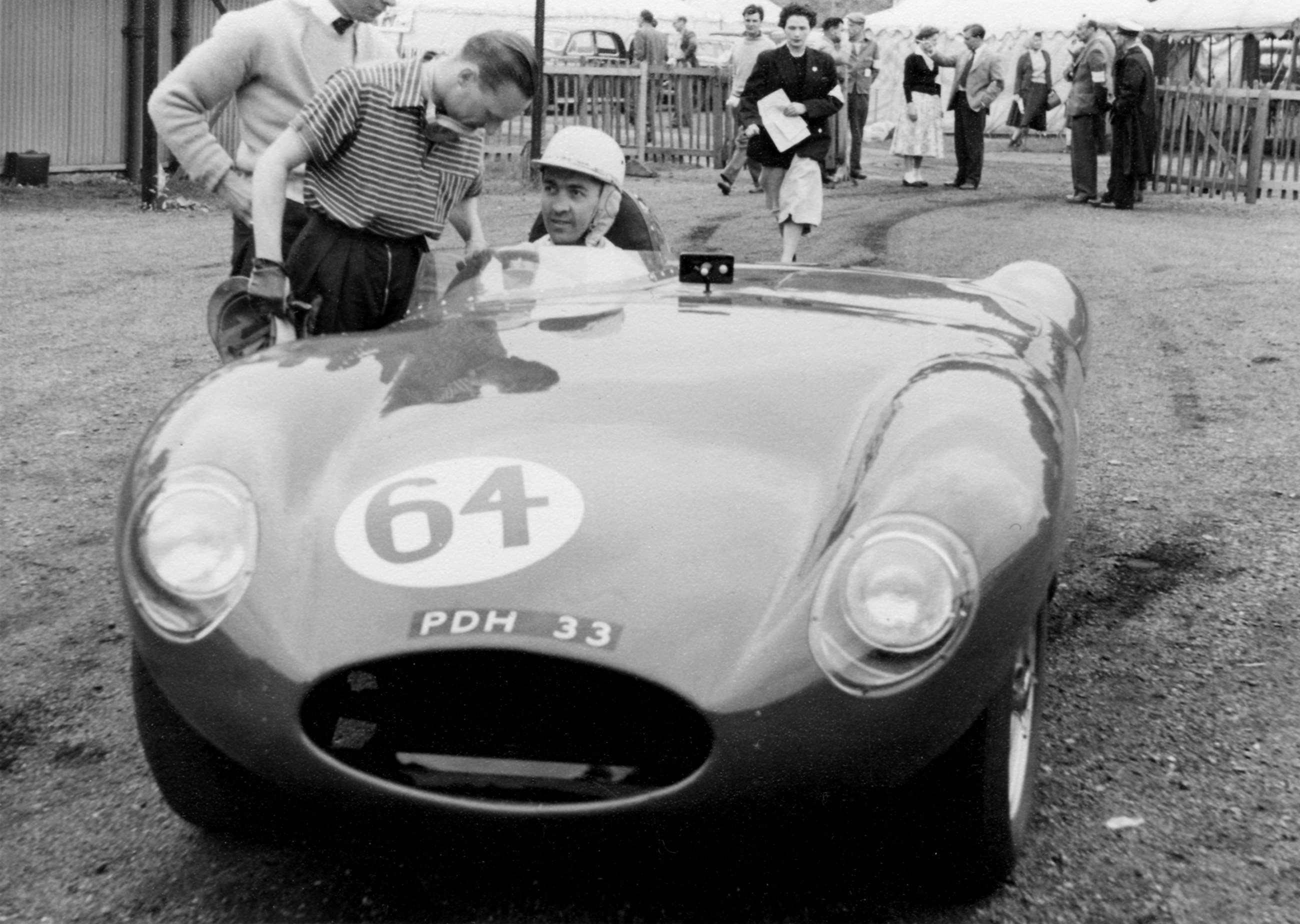 Customer sports cars were also made by Cooper, such as this big Cooper-Jaguar driven by Stuart Lewis-Evans (seated) with owner at left, Mr Bernard Charles ‘Bernie’ Ecclestone...