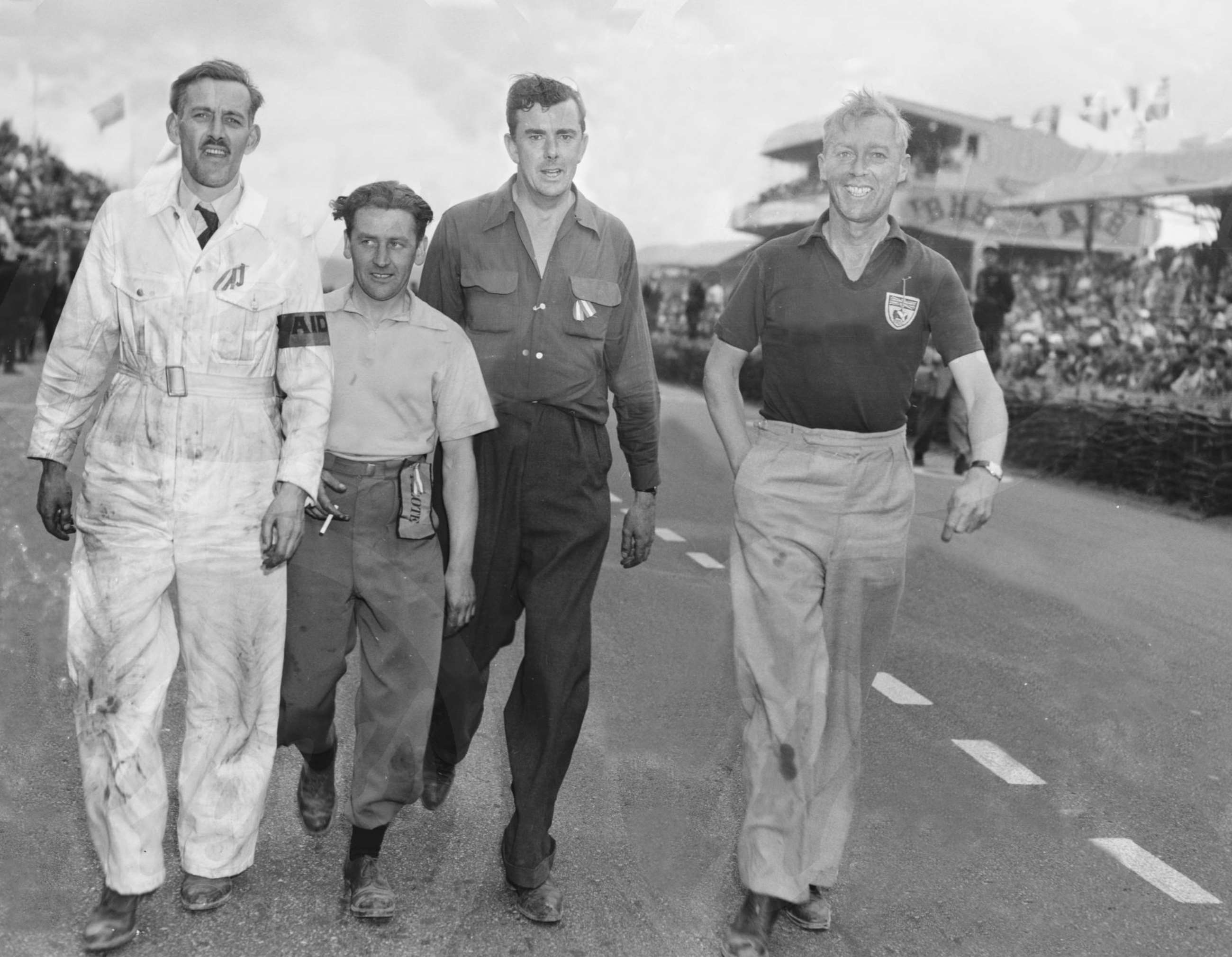 Happy Jaguar group walking to the podium ceremony after winning at Le Mans 1953 with Rolt/Hamilton’s C-Type. 2nd left is Norman Dewis, then Lofty England and team manager Mort Morris-Goodall.