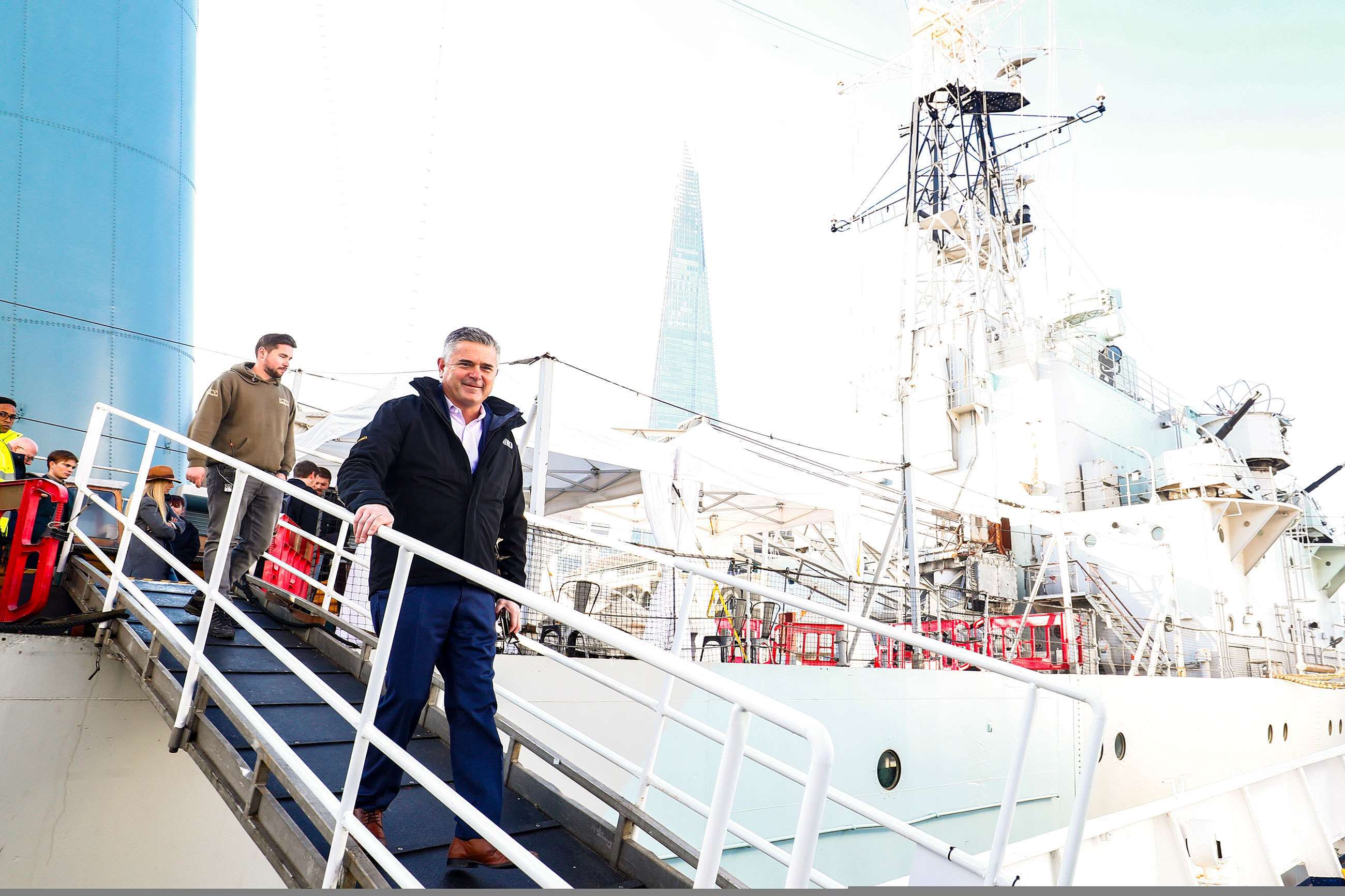 Former F1 driver Gil de Ferran disembarking HMS Helena at the series's launch in London. 