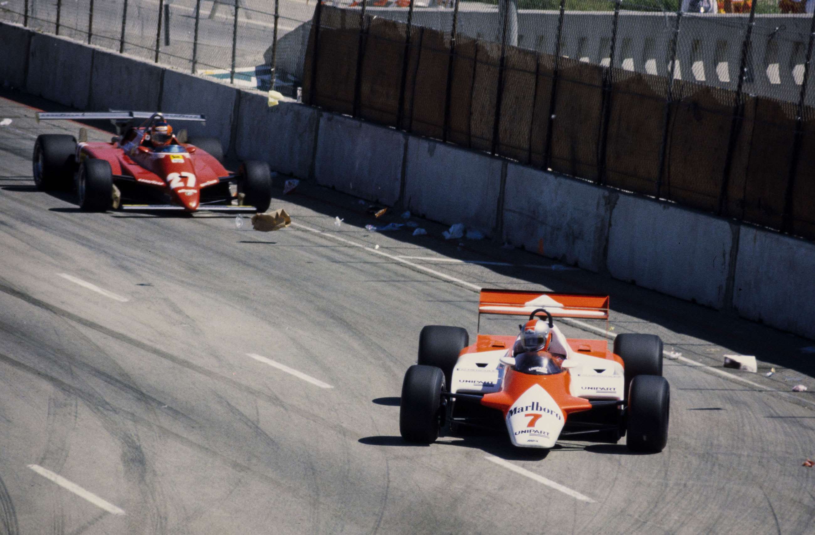 Watson in his McLaren MP4-1B Ford leading Gilles Villeneuve in his Ferrari 126C, Long Beach, 1982. 