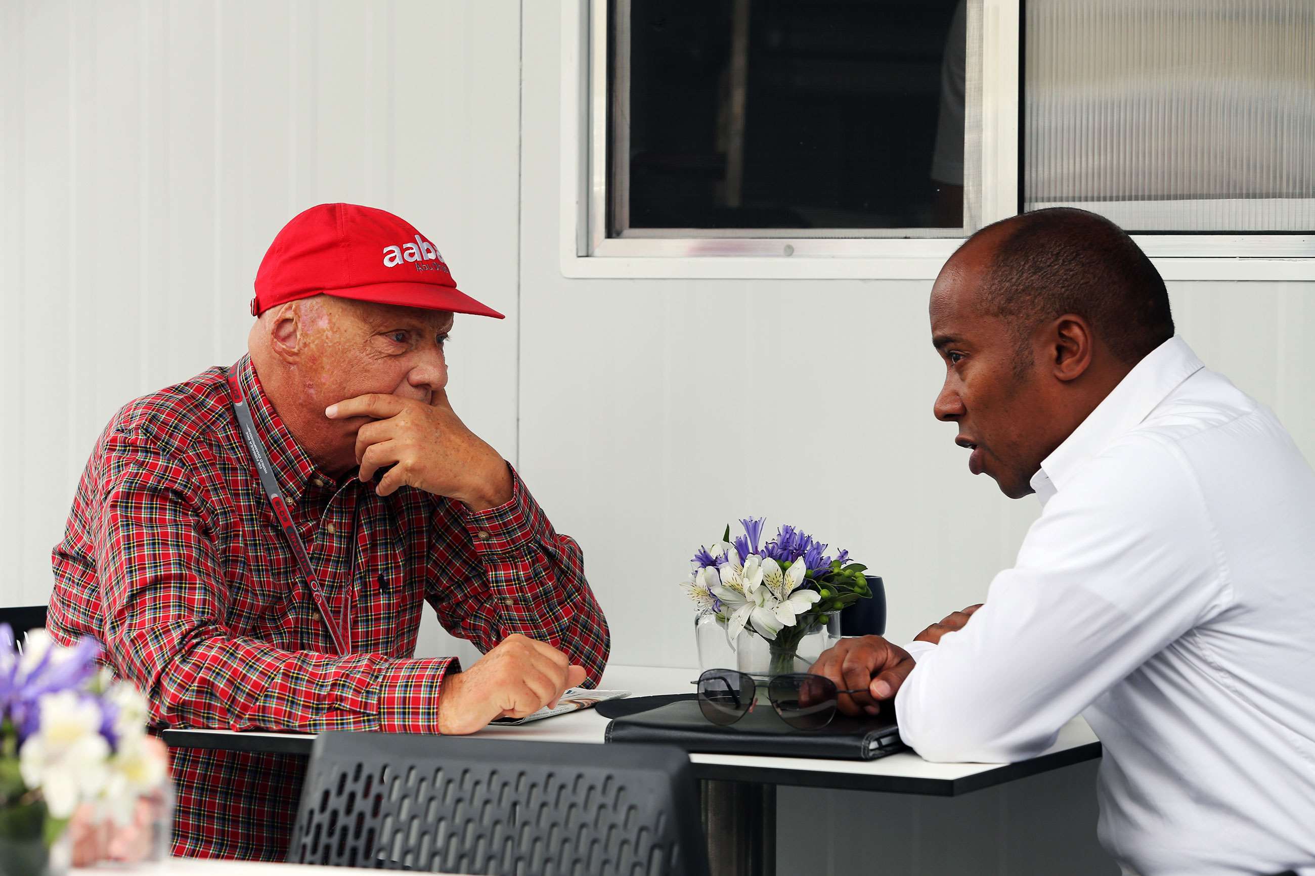 Niki Lauda talking to Anthony Hamilton in Brazil, 2012. 