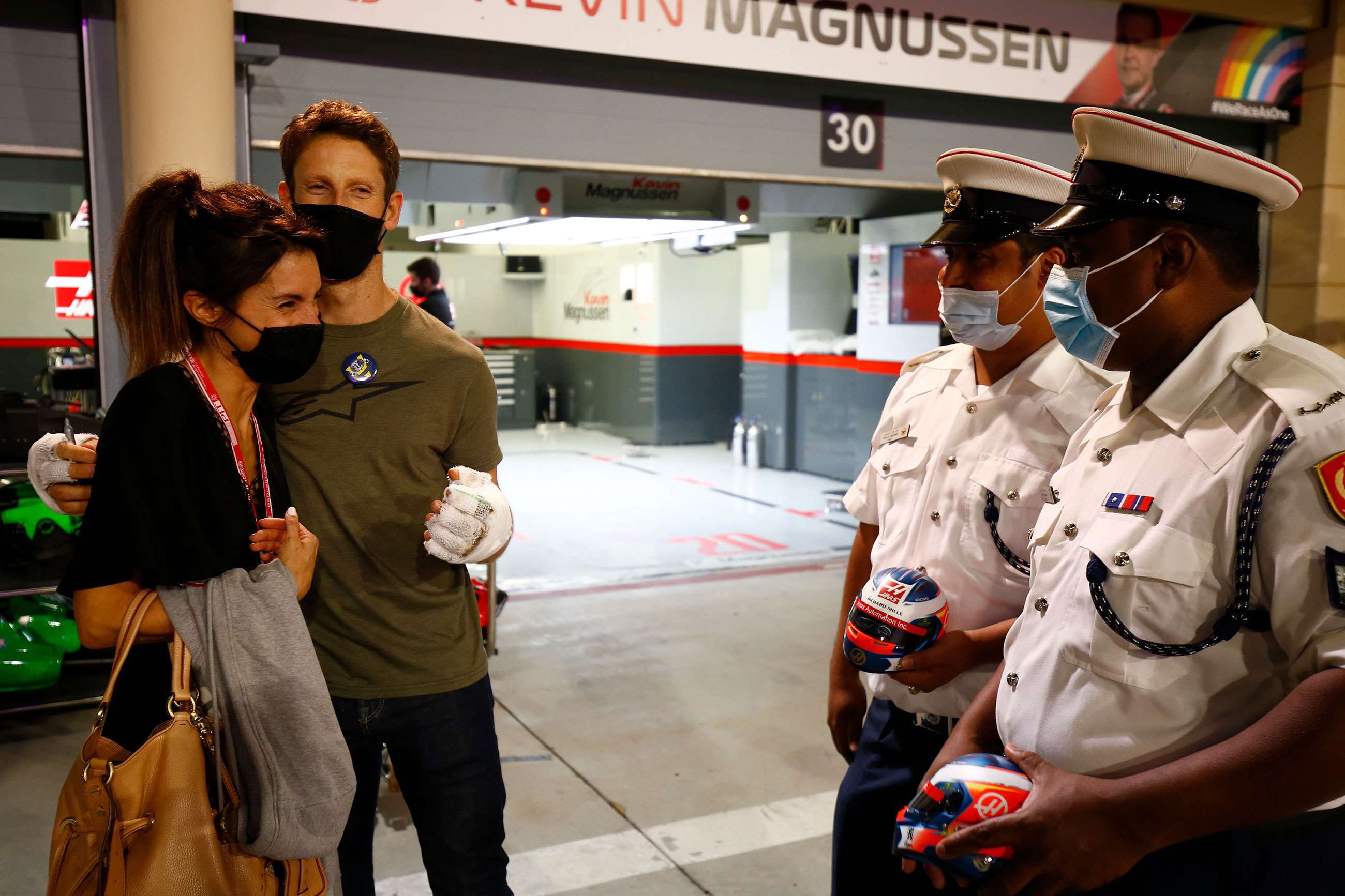 Romain Grosjean with his wife Marion meeting the marshals who helped control the fire, aiding Romain's escape from the wreckage. 