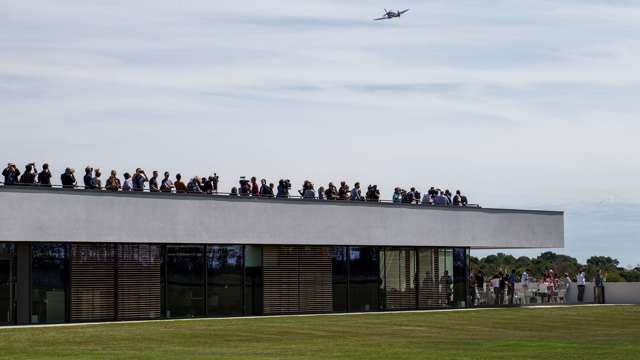 silver-spitfire-over-aerodrome-building.jpg