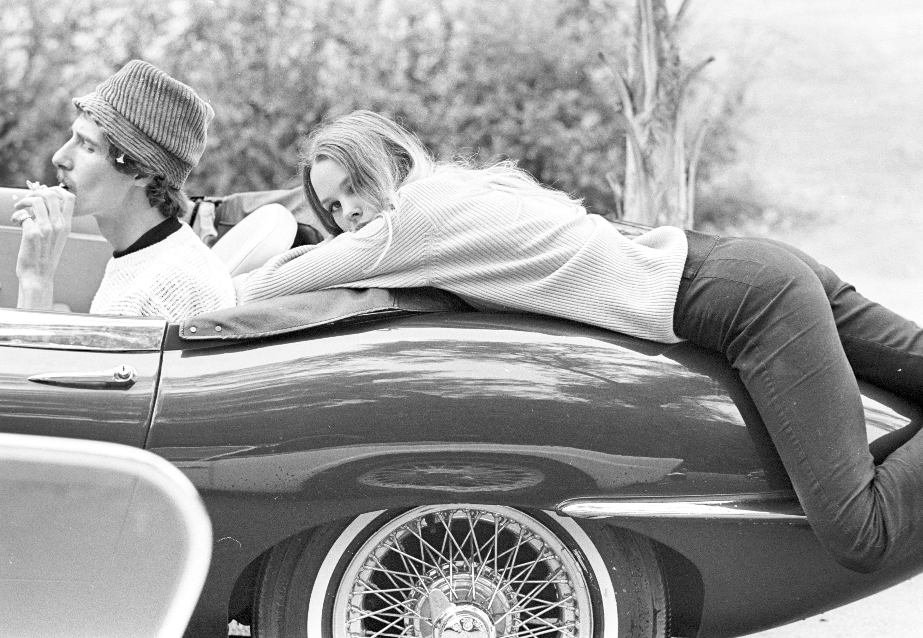 John and Michelle Phillips of the Mamas and the Papas pose with an E-type